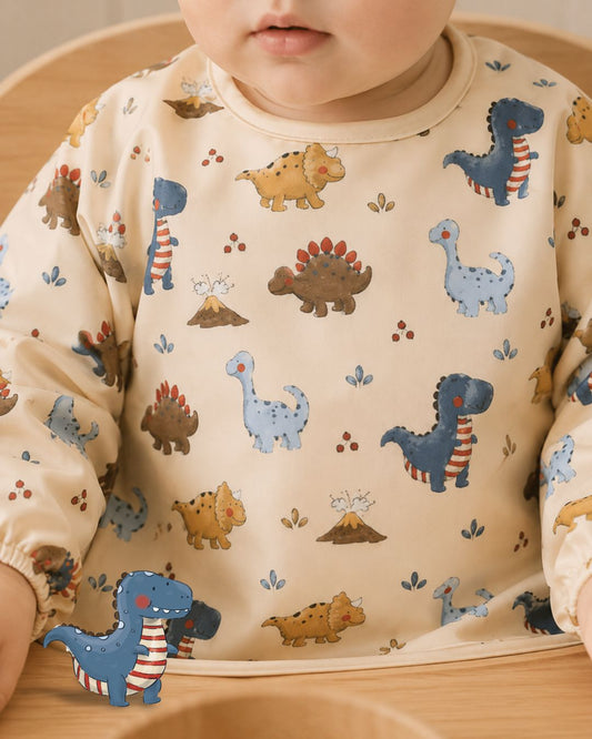 Baby wearing Tiny Trees dinosaur long sleeve bib
